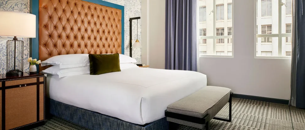 kimpton-denver-colorado-hotel-monaco-guestroom-suite-monte-carlo-sleeping-room-tv-headboard-bed-b34cb2fe